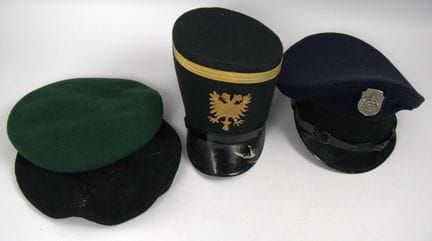 A variety of uniform headgear, including berets, s