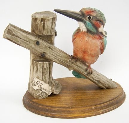 Porcelain figurine of a kingfisher perched on a br