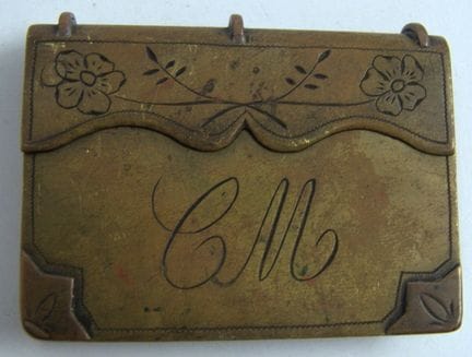 Antique brass storm lighter in the shape of a book