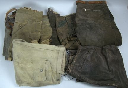 Lot of leather pants, various sizes, styles, and c