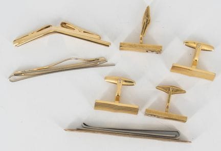 A small assortment of gold-plated cufflinks and ti