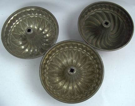 Three antique copper Gugelhupf cake pans. Each is 