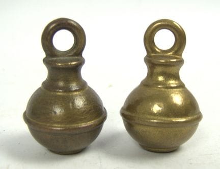 Two brass spherical weights, also known as "Perita