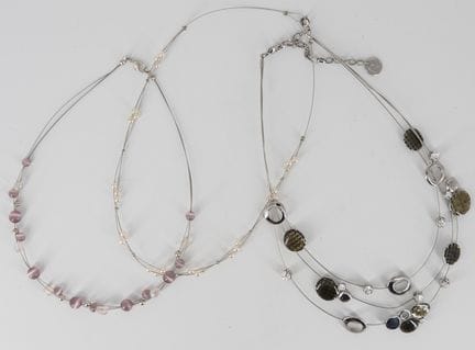 Three unique costume jewelry necklaces.