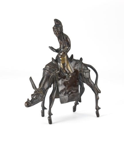 Una figura de bronce de estilo arcaico que represe