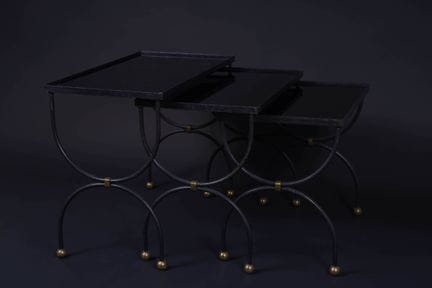 In the style of MAISON JANSEN. 
Nesting tables. 
T