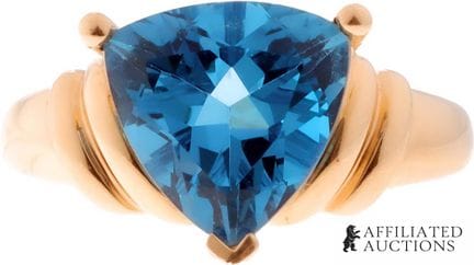 Bague en or jaune 14 carats avec topaze bleue tail