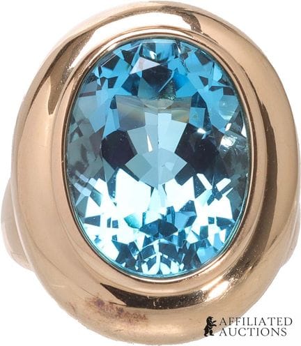 Bague en or jaune 14 carats et topaze bleue. Poinç