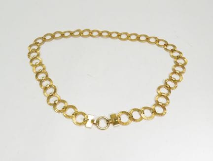 YVES-SAINT-LAURENT. Cinturón de metal dorado. Firm