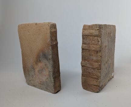 PAIR OF TERRACOTTA BOOKENDS shaped like bound book