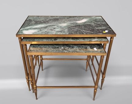 Three nesting tables with bronze bases and veined 
