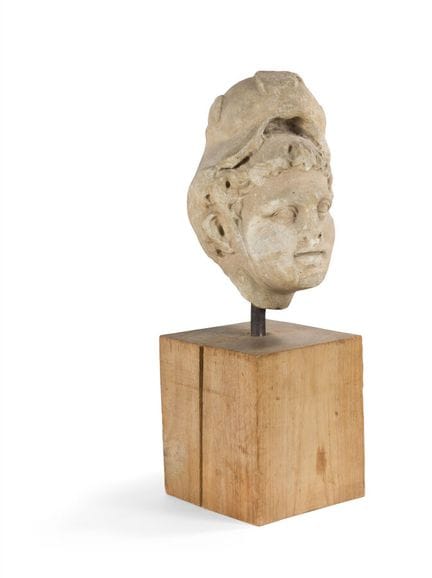 HEAD FROM A VERY HIGH RELIEF
depicting a helmeted 