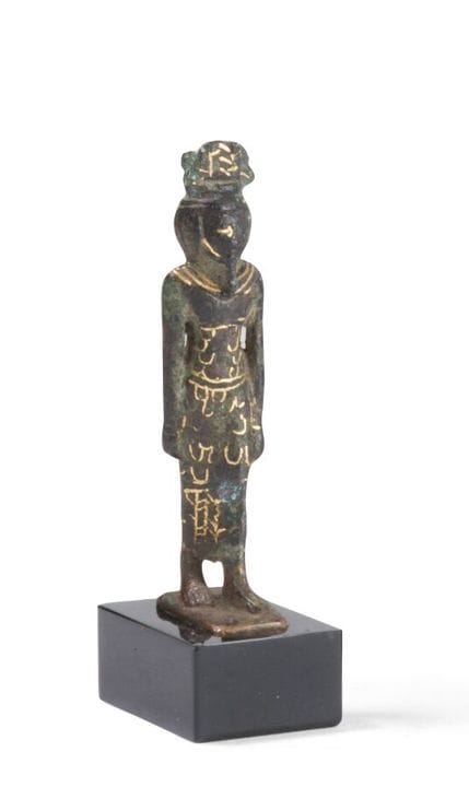 AMULETS
depicting a female deity wearing a tapered