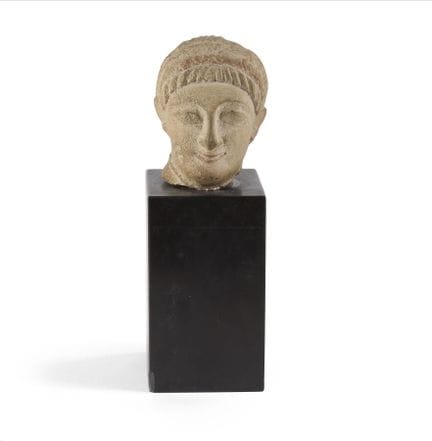 MALE HEAD FROM A VOTIVE STATUETTE
The figure has a