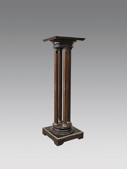 Mahogany stool resting on four fluted brass legs (