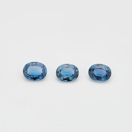 Three oval-cut blue sapphires, two measuring 7 x 5