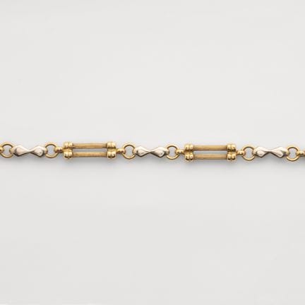 A two-tone gold link bracelet featuring alternatin