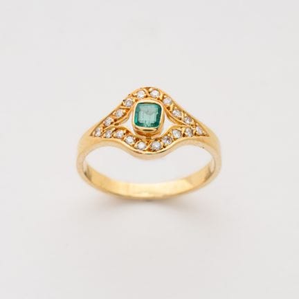 Gold ring with an octagonal-cut emerald set in a b