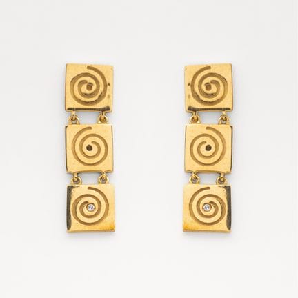 Gold earrings featuring three square links with a 
