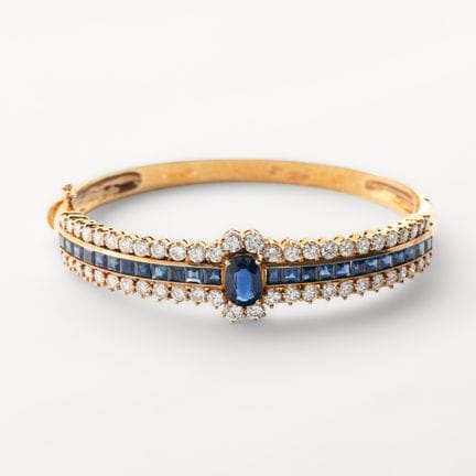 Pulsera esclava en oro con un zafiro azul central 