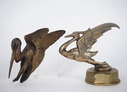 Two bronze radiator caps decorated with wading bir