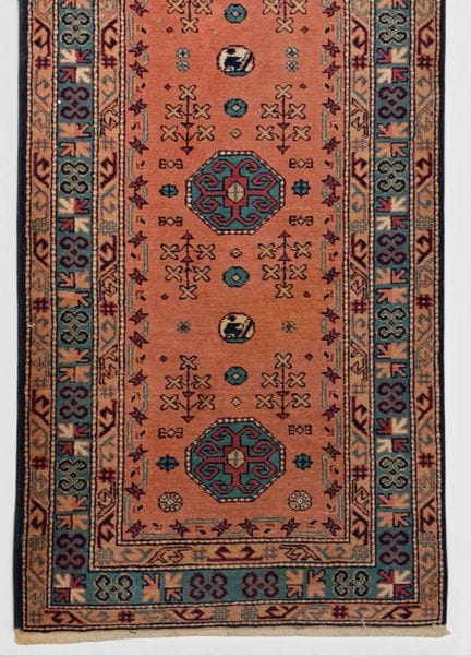 Wool gallery rug with medallion motifs on a pink b