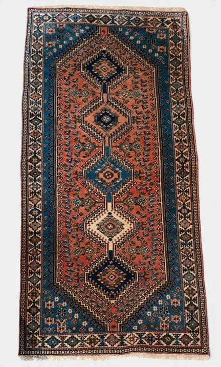 Wool gallery rug with medallion motifs on a pink a