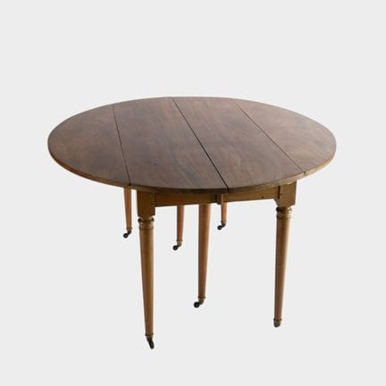 Wooden side table with folding flaps, on a base wi