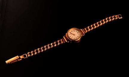 Women's wristwatch with a metal and brass case and