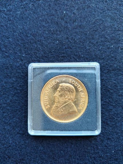 1 1-ounce yellow gold Krugerrand 
Made of gold (90