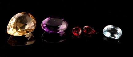 Set of semi-precious stones on paper, including:
-