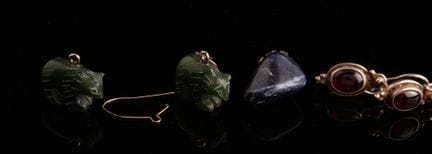 A pair of green semi-precious stone earrings carve
