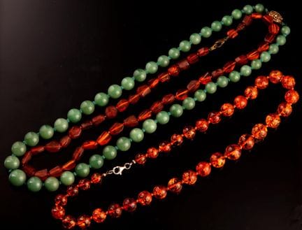 Two amber bead necklaces and one green jade bead n