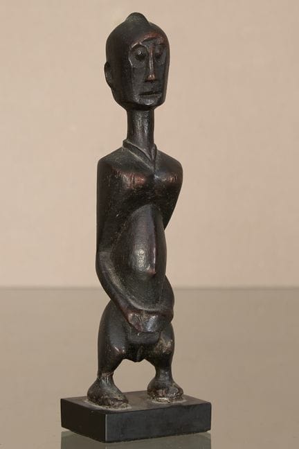 Ivory Coast
Female statuette  Carved from wood on 