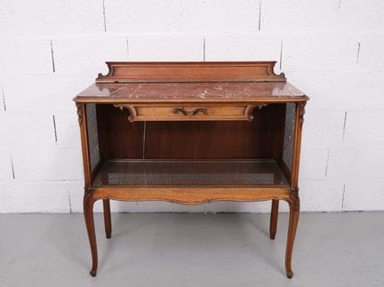 Sideboard with a marble top and cane-wrapped legs.