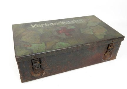 德国。这款名为“Verbandkasten”的急救箱整体涂成灰蓝色，但盖子上却涂有非典型的斑驳迷彩图