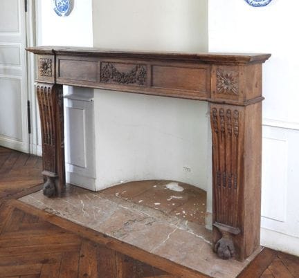 FIREPLACE SURROUND in molded and carved oak; the j