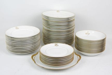 LIMOGES. Set of white porcelain tableware with gol