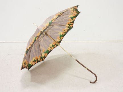 Umbrella with a floral border design on a mauve ba
