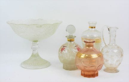 Four liqueur bottles and a glass and crystal fruit