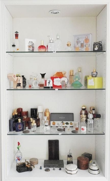 The display case contains items on four levels, in