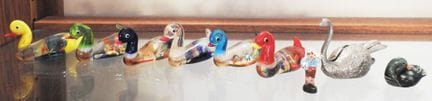Collection of miniature Murano-style glass ducks.
