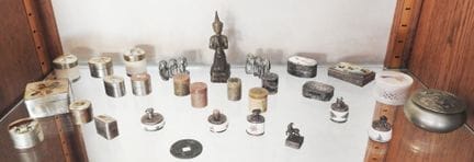 A collection of pill boxes from various countries,