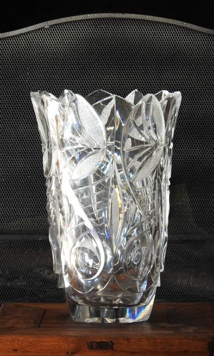 A large, flared, hand-cut crystal vase with rich f