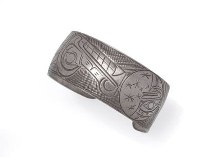 Open silver bracelet featuring a wolf and moon des