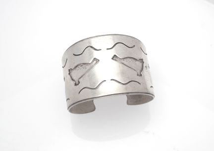 Open silver bracelet decorated with four stylized 
