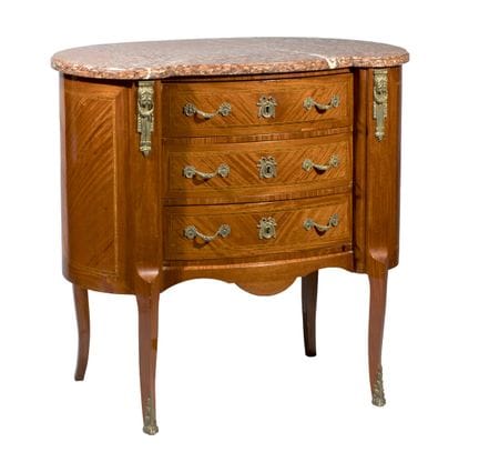 Pequeña cómoda de forma reniforme, de madera chapa