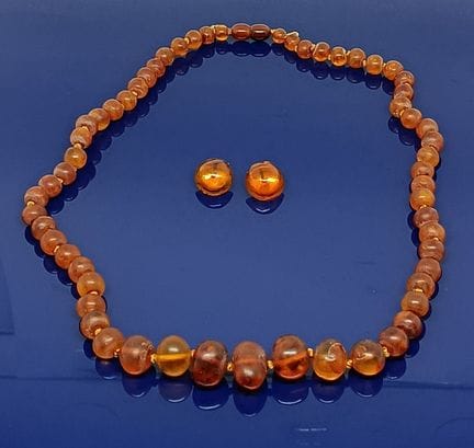 Collier et paire de clip en ambre présumé.
