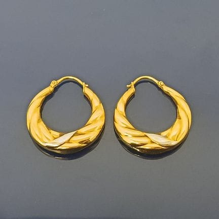 Boucles d'oreilles créoles en or deux tons 750‰. 
