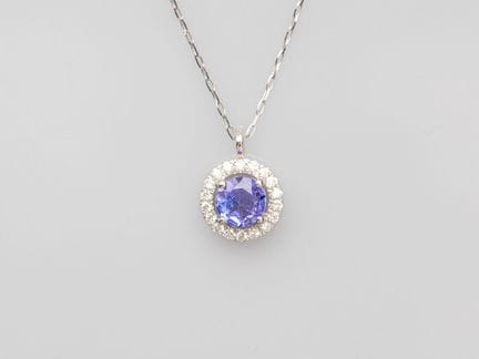 Platinum pendant set with a round facetted tanzani